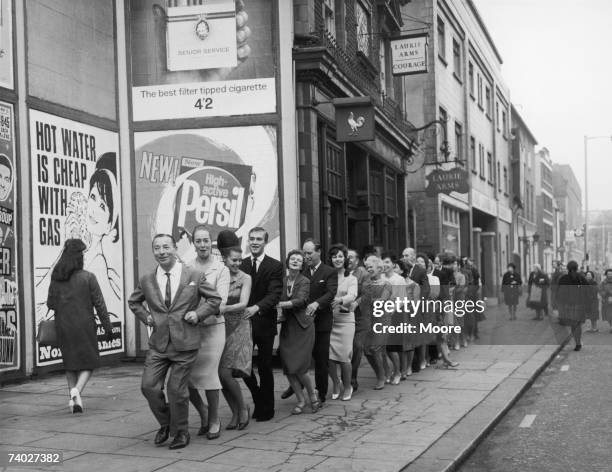 Big Bandleader Joe Loss introduces the Finnjenka, a Finnish version of the Conga, outside the Hammersmith Palais, 22nd October 1964. He is...