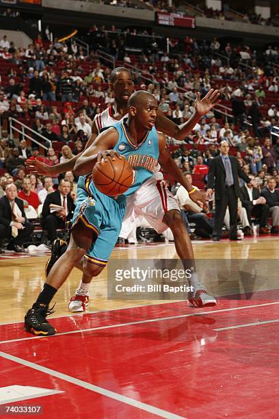 Chris Paul of the New Orleans/Oklahoma City Hornets drives baseline against Rafer Alston of the Houston Rockets during the game at the Toyota Center...