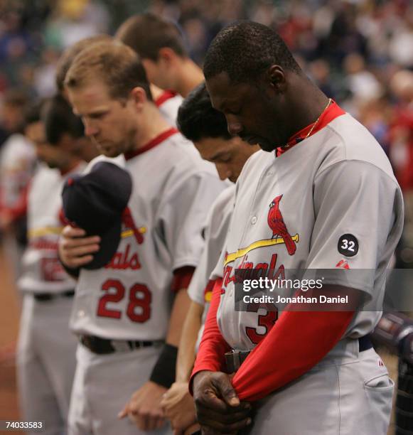 Members of the St. Louis Cardinals including Gary Bennett, So Taguchi and Preseton Wilson, bow their heads during a moment of silence for teammate...