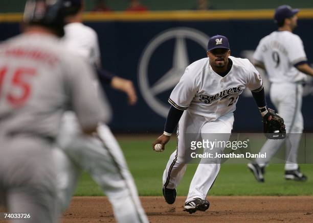 Prince Fielder of the Milwaukee Brewers prepares to flip the ball to teammate Jeff Suppan for an out against Jim Edmonds of the St. Louis Cardinals...