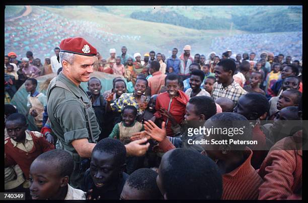 French soldier gives candy to Tutsi children June 24, 1994 at the Nyarushishi Tutsi refugee camp on the Zaire border in Gisenyi, Rwanda. The French...