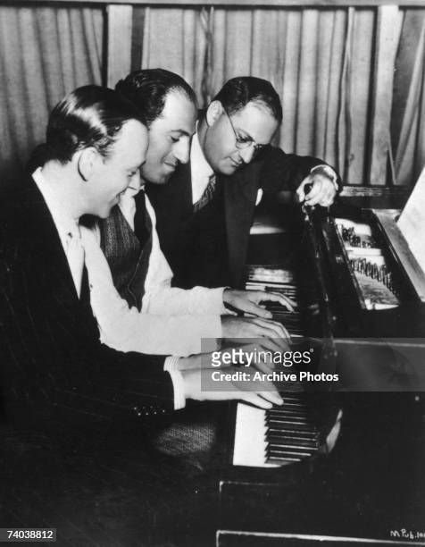Actor Fred Astaire with composer and lyricist George and Ira Gershwin on the Hollywood set of the musical 'Shall We Dance', 1937.