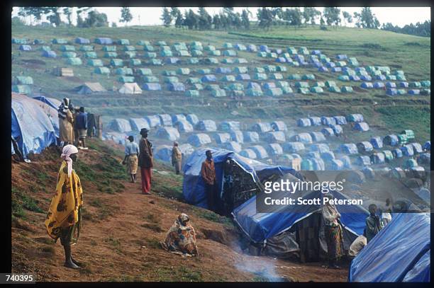 Inhabitants awake June 24, 1994 at the Nyarushishi Tutsi refugee camp on the Zaire border in Gisenyi, Rwanda. The camp is run by Hutu prefect...