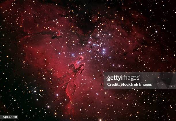 the eagle nebula, also known as messier 16 or ngc 6611, is a young open cluster of stars in the constellation serpens. - nebulosa del águila fotografías e imágenes de stock