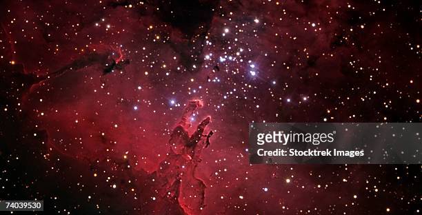 the eagle nebula, also known as messier 16 or ngc 6611, is a young open cluster of stars in the constellation serpens. - nebulosa del águila fotografías e imágenes de stock