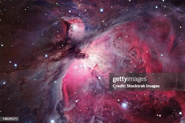 a close up of the orion nebula, also known as messier 42 or ngc 1976, is a diffuse nebula situated south of orion's belt. it is one of the brightest nebulae, and is visible to the naked eye in the night sky. - orion belt stock pictures, royalty-free photos & images