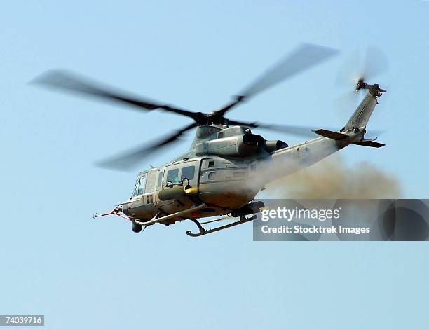 h-1 upgrades test pilot, launches a pair of 2.75 inch rockets from uh-1y #1 at fort a.p. hill va. during the final phase of rocket ingestion and accuracy testing on the y model. - huey helicopter stock pictures, royalty-free photos & images