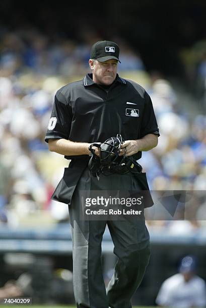 Umpire Paul Emmel stands near the plate during the game between the Los Angeles Dodgers and the Colorado Rockies at Dodger Stadium in Los Angeles,...