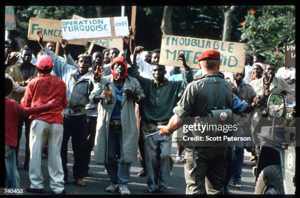 Hutus celebrate the arrival of French troops at the Zaire border June 24, 1994 in Rwanda. The Hutus believe that the French will take an active role...