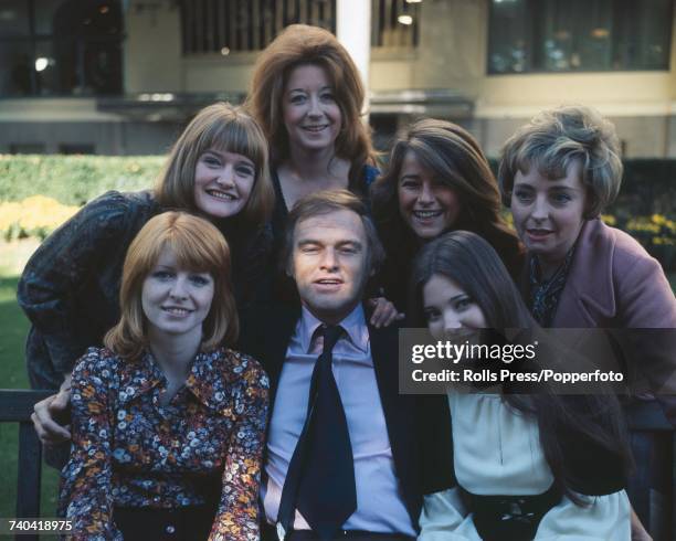 Australian-born actor Keith Michell , who is playing the part of King Henry VIII in the film 'Henry VIII and His Six Wives', with the actresses who...