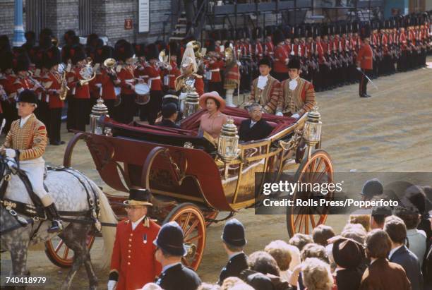 Emperor Hirohito of Japan rides with Queen Elizabeth II in an open carriage to Buckingham Palace, at the start of a three-day visit to London on 5th...