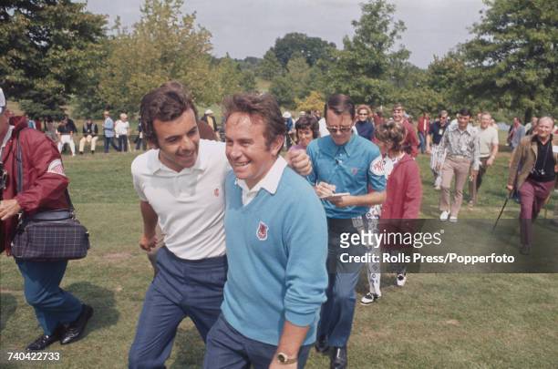 Great Britain Ryder Cup team member, English golfer Tony Jacklin puts his arm around Welsh golfer Brian Huggett during play on the first day of the...