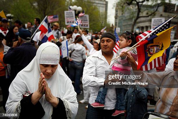 Woman prays during an immigration reform rally in Union Square on May 1, 2007 in New York City. The protest was one of many held around the country...