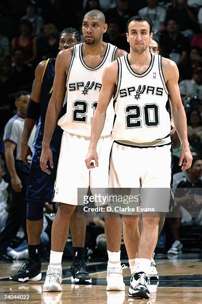 Manu Ginobili and Tim Duncan of the San Antonio Spurs look on against the Denver Nuggets in Game Two of the Western Conference Quarterfinals during...