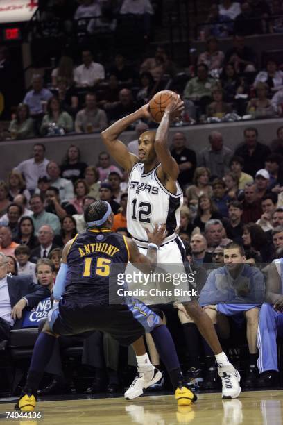 Bruce Bowen of the San Antonio Spurs looks to pass against Carmelo Anthony of the Denver Nuggets in Game Two of the Western Conference Quarterfinals...