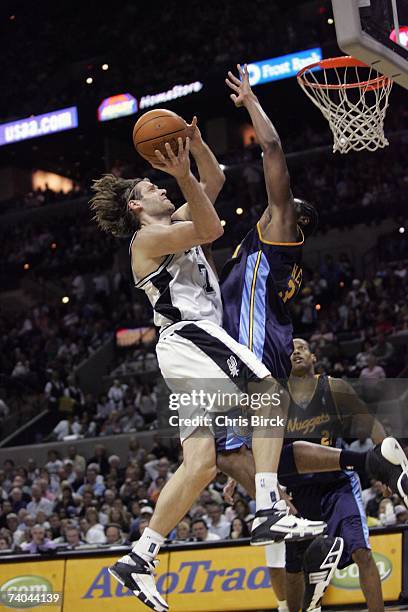 Fabricio Oberto of the San Antonio Spurs drives to the basket against Nene of the Denver Nuggets in Game Two of the Western Conference Quarterfinals...