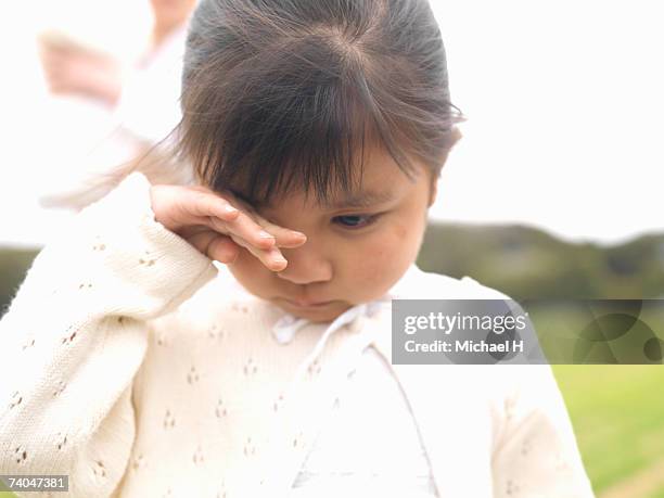 girl (6-7) standing in field, crying - kid rubbing eyes stock pictures, royalty-free photos & images