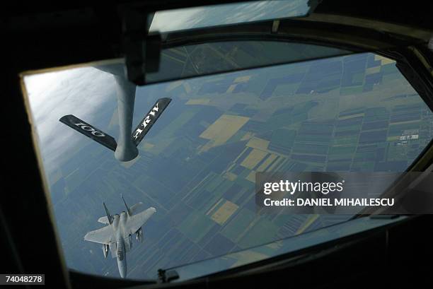 Air Force F15 fighter jet approaches a refueling plane 02 May 2007 during joint exercises with Romanian air force teams at the Mihail Kogalniceanu...