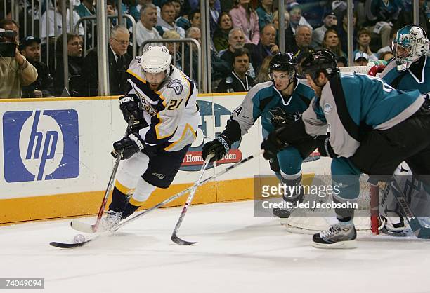 Peter Forsberg of the Nashville Predators is pressured by Marc-Edouard Vlasic of the San Jose Sharks as he skates with the puck in Game 4 of the...