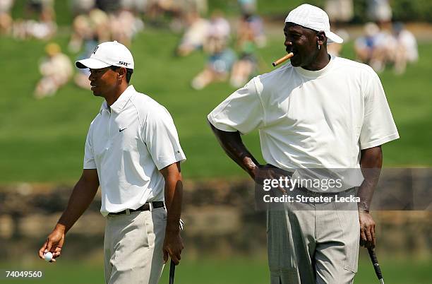 Tiger Woods and Michael Jordan walk around on the 17th green during the Pro-am at the Wachovia Championship at Quail Hollow Country Club on May 2,...