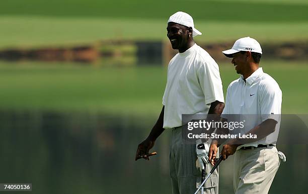 Tiger Woods and Michael Jordan smile on the 17th green during the Pro-am at the Wachovia Championship at Quail Hollow Country Club on May 2, 2007 in...