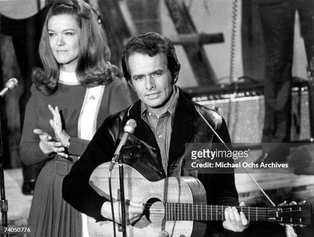 Country musician Merle Haggard performs on stage with Bonnie Owens during a late 1960's concert.