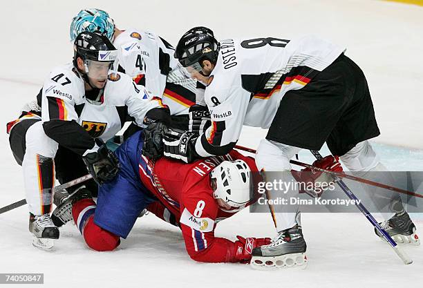 Germany's Christoph Ullmann and Sebastian Osterloh fights for the puck with Norway's Mads Hansen during the IIHF World Ice Hockey Championship...