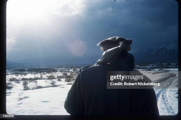 Guerrilla soldier stands with a shell near a remote rebel base in the Safed Koh mountains February 10, 1988 in Afghanistan. A Soviet-supported...