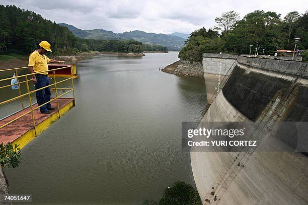 An operator of the Costa Rican Energy Institute looks at the low water level registered at the Cachi dam, some 30 km east of San Jose, on may 2nd,...