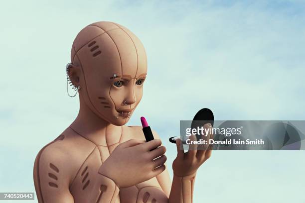 robot woman with pierced face applying lipstick - body piercings stock-fotos und bilder