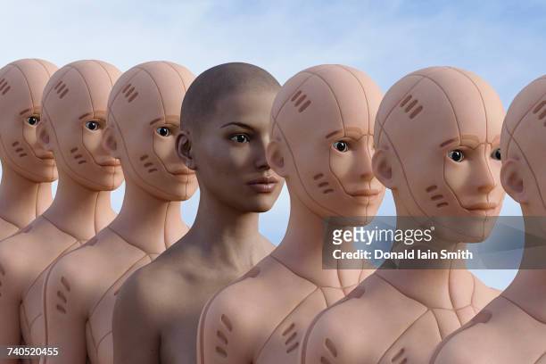 woman standing in row of robots - cyborg stock pictures, royalty-free photos & images