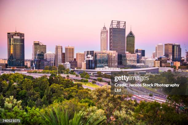 foliage and roads near highrises, perth, western australia, australia - perth australia fotografías e imágenes de stock