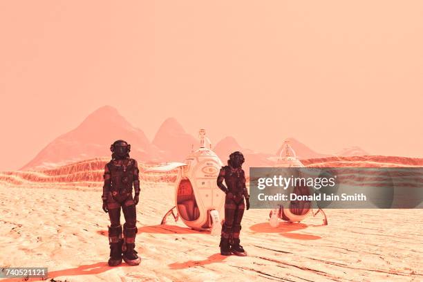 futuristic space travelers near spaceships - space man on mars imagens e fotografias de stock