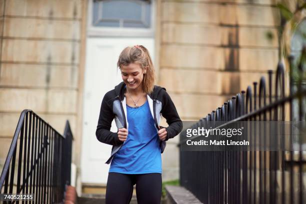 young female runner moving front door down stairway - pants down woman fotografías e imágenes de stock