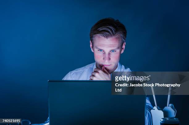 serious caucasian businessman using laptop - white night melbourne stock pictures, royalty-free photos & images