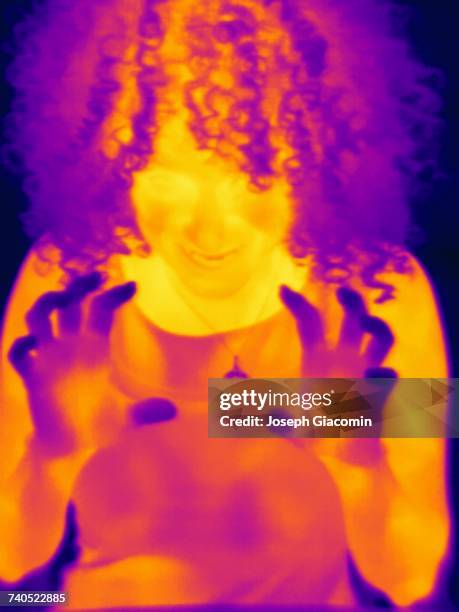 thermal image portrait of mid adult woman with grabbing hands - harrow london stock pictures, royalty-free photos & images