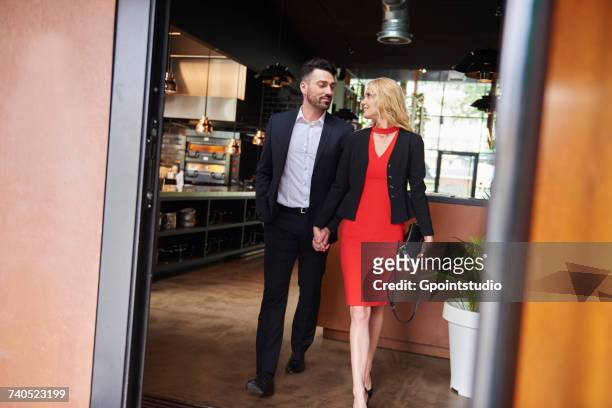 glamorous couple leaving restaurant - leaving restaurant stock pictures, royalty-free photos & images