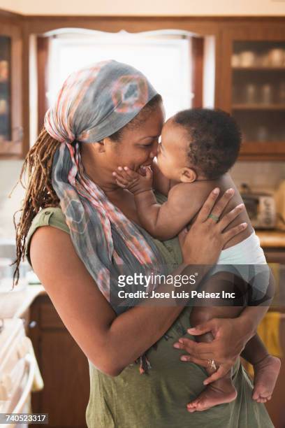 Black mother hugging baby son