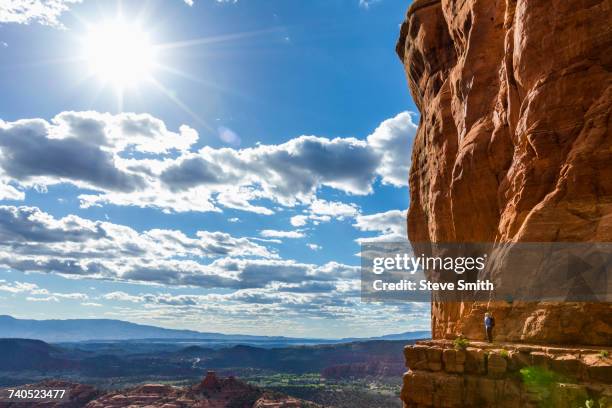 caucasian woman hiking on ledge of cliff - sightseeing in sedona stock pictures, royalty-free photos & images
