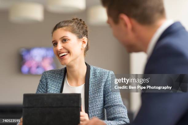 businesswoman meeting male colleague in boardroom - strategic initiative stock pictures, royalty-free photos & images