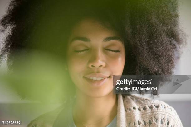 portrait of african american woman with eyes closed - routine foto e immagini stock