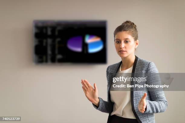 young businesswoman explaining during office presentation - initiative foto e immagini stock