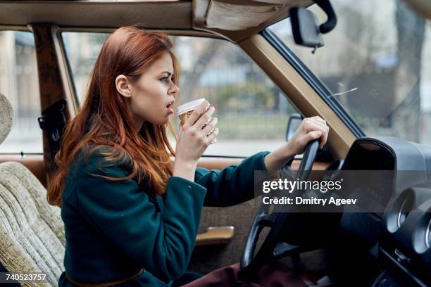 angry caucasian woman driving car and drinking coffee - car profile stock pictures, royalty-free photos & images