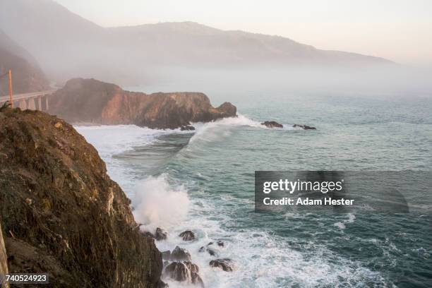 waves splashing on rocks at cliffs - oakland california fotografías e imágenes de stock