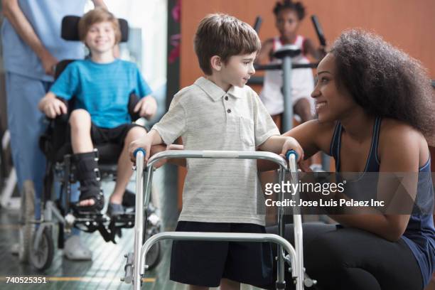 physical therapists helping children - mobility walker stock pictures, royalty-free photos & images