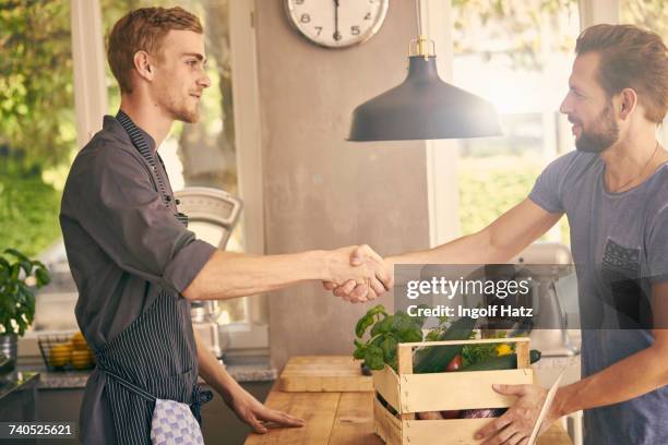 chef and vegetable delivery man shaking hands - fresh deals fotografías e imágenes de stock