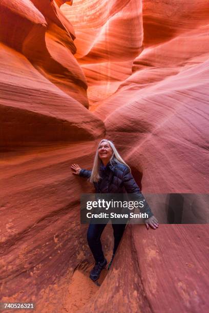 caucasian woman walking in rock formation - slot canyon fotografías e imágenes de stock