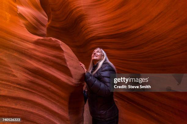 caucasian woman standing in rock formation - slot canyon fotografías e imágenes de stock