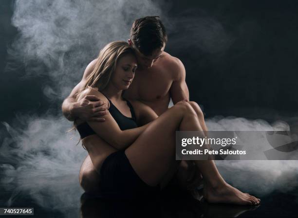 man carrying woman against smoky background - hesitant to dance stock pictures, royalty-free photos & images