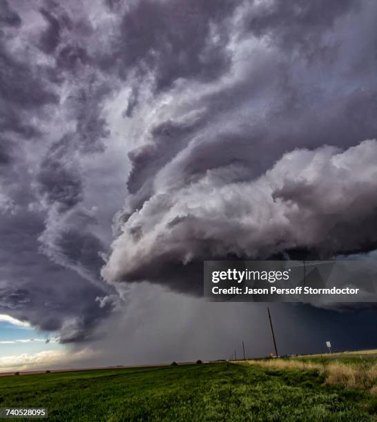 rotating supercell clouds over rural area, cope, colorado, united states, north america - supercell stockfoto's en -beelden